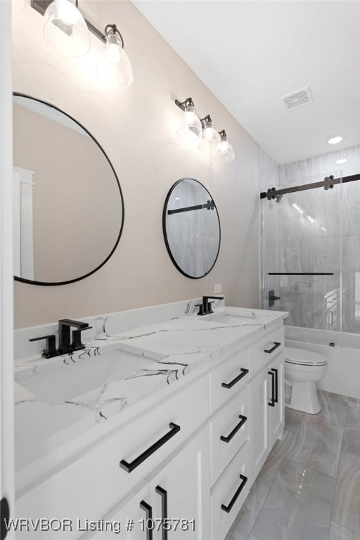 full bathroom featuring vanity, toilet, and tiled shower / bath