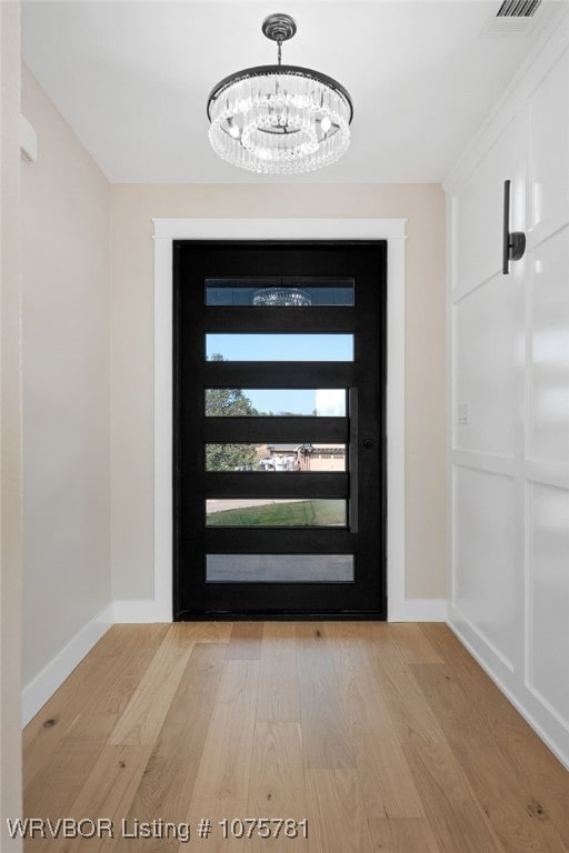 entryway featuring a notable chandelier and light hardwood / wood-style floors