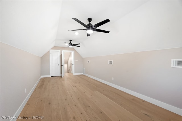 additional living space featuring ceiling fan, light hardwood / wood-style floors, and vaulted ceiling