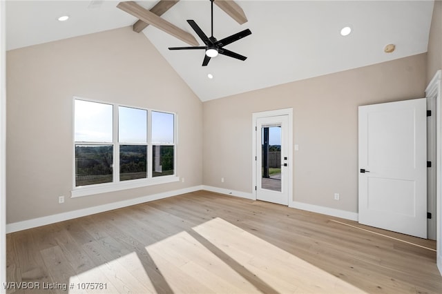 unfurnished room featuring ceiling fan, beamed ceiling, light wood-type flooring, and high vaulted ceiling