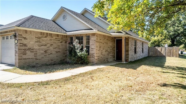 view of front of property with a front yard and a garage