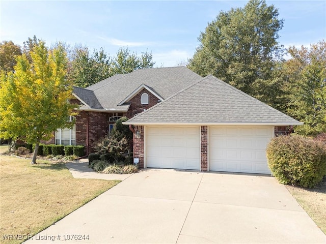 view of front of house with a front yard and a garage