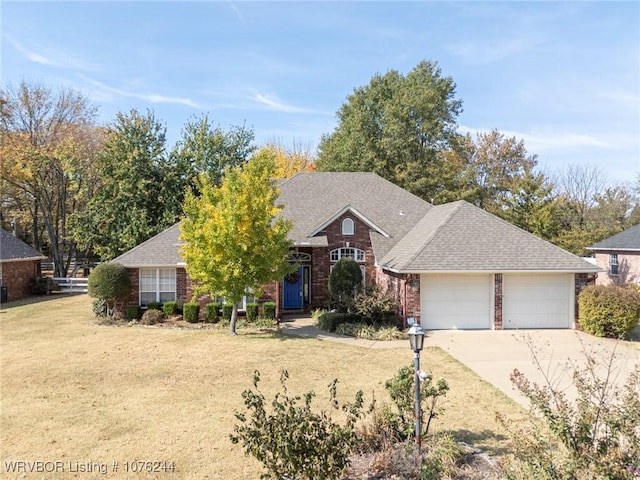 view of front of home featuring a garage and a front lawn