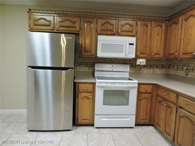 2211 Breckenridge Ter, Greenwood, AR 72936 - kitchen with white appliances, light tile patterned flooring, crown molding, decorative backsplash, and brown cabinets