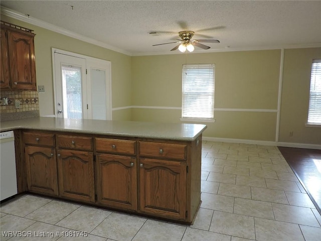 2211 Breckenridge Ter, Greenwood, AR 72936 - kitchen featuring a peninsula, white dishwasher, ceiling fan, light tile patterned flooring, and crown molding