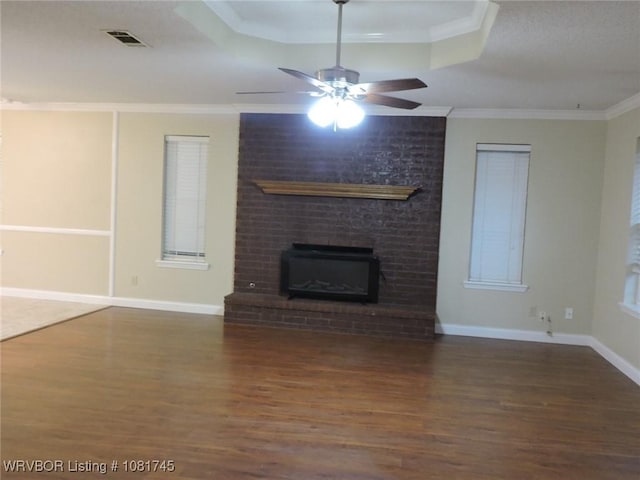 2211 Breckenridge Ter, Greenwood, AR 72936 - unfurnished living room featuring wood finished floors, ceiling fan, a raised ceiling, ornamental molding, and a brick fireplace