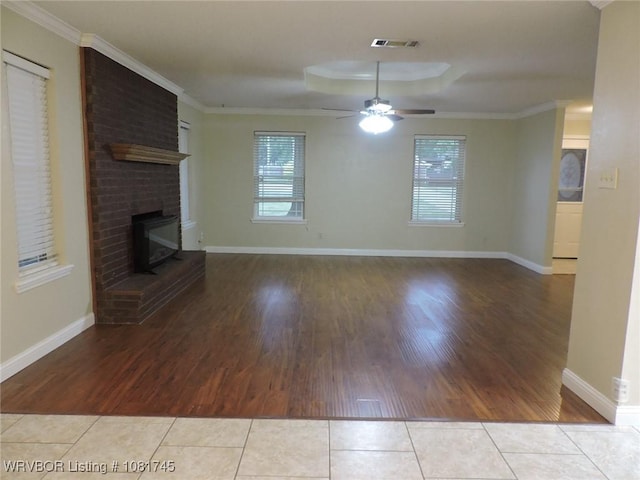 2211 Breckenridge Ter, Greenwood, AR 72936 - unfurnished living room with tile patterned floors, plenty of natural light, a fireplace, ceiling fan, and ornamental molding