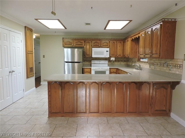 2211 Breckenridge Ter, Greenwood, AR 72936 - kitchen featuring white appliances, a peninsula, brown cabinetry, tasteful backsplash, and ornamental molding