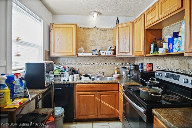 kitchen with stainless steel range with electric stovetop, black dishwasher, light tile patterned flooring, a textured ceiling, and sink