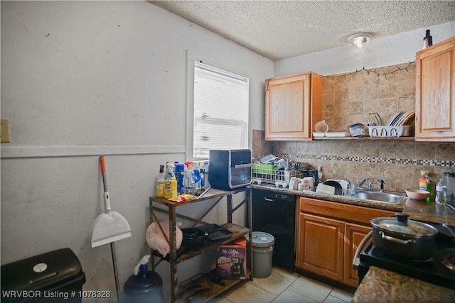 kitchen featuring backsplash, black appliances, sink, light tile patterned flooring, and a textured ceiling