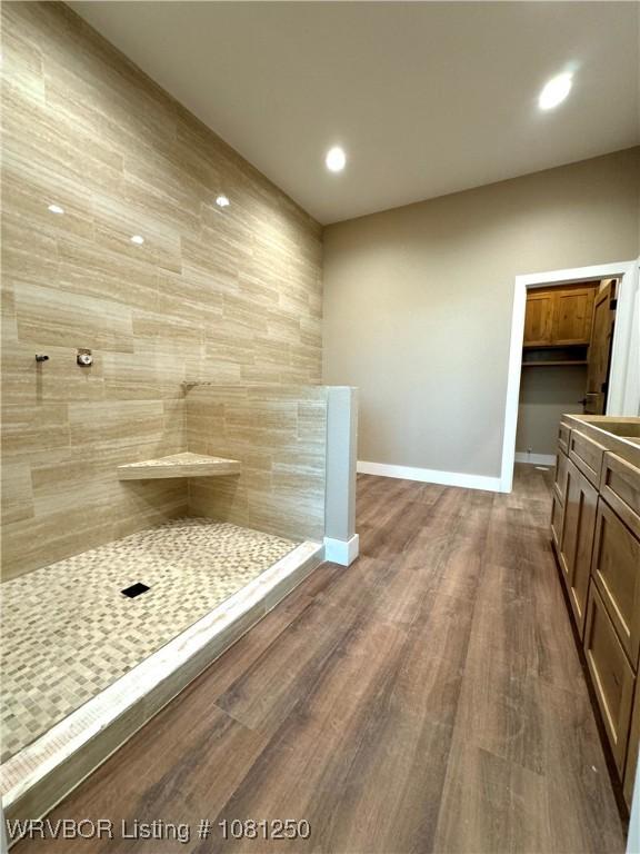 4457 Radio Tower Rd, Van Buren, AR 72956 - bathroom with wood finished floors, vanity, a tile shower, baseboards, and recessed lighting
