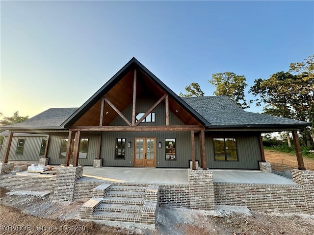 4457 Radio Tower Rd, Van Buren, AR 72956 - back of house at dusk with roof with shingles, french doors, and a porch