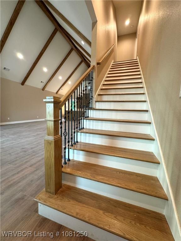 4457 Radio Tower Rd, Van Buren, AR 72956 - stairs featuring beam ceiling, wood finished floors, baseboards, recessed lighting, and high vaulted ceiling