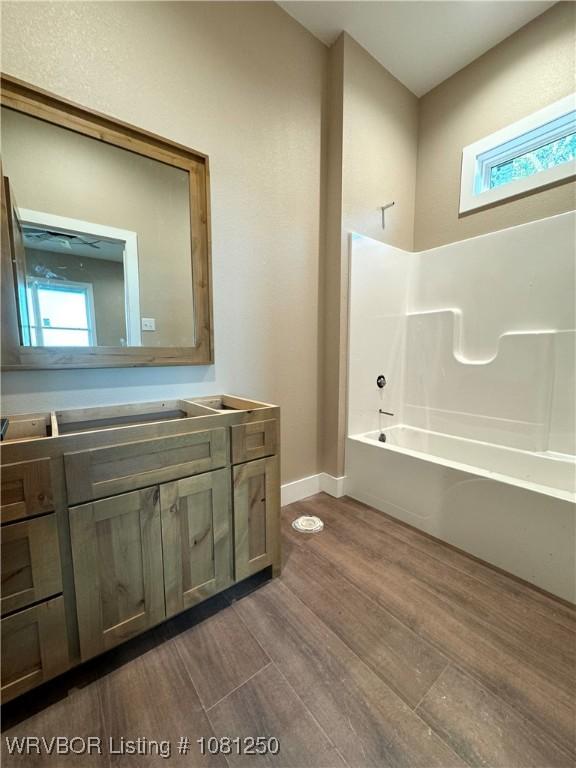 4457 Radio Tower Rd, Van Buren, AR 72956 - full bath with vanity, wood finished floors, baseboards, and shower / bathtub combination