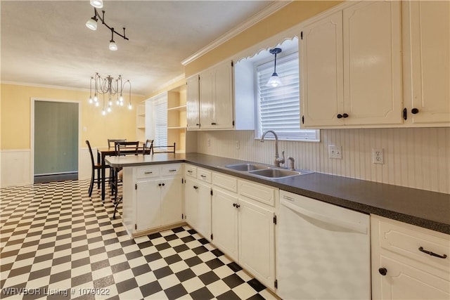 kitchen with white dishwasher, sink, white cabinetry, and pendant lighting