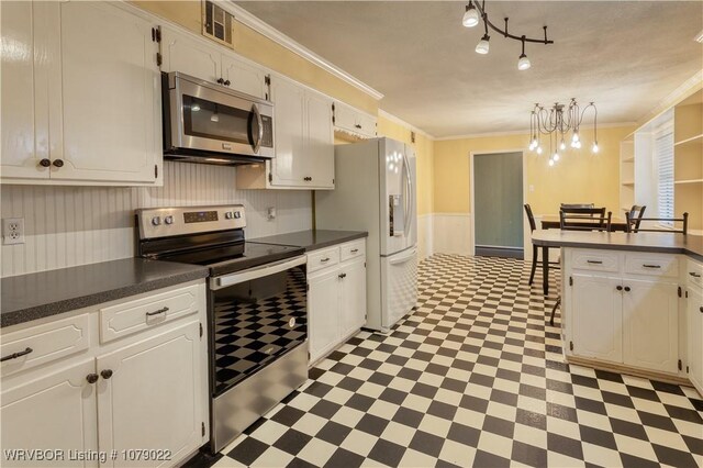 kitchen featuring stainless steel appliances, ornamental molding, and white cabinets