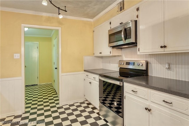 kitchen with white cabinetry, appliances with stainless steel finishes, and crown molding