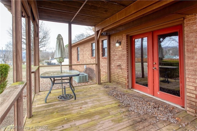 wooden terrace featuring cooling unit and french doors