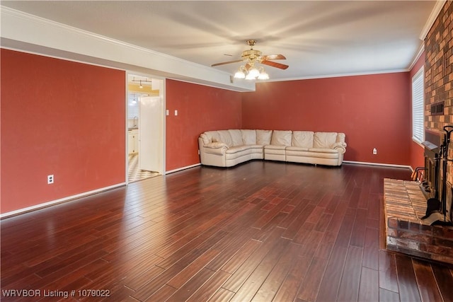 unfurnished living room featuring crown molding, ceiling fan, dark hardwood / wood-style floors, and a fireplace