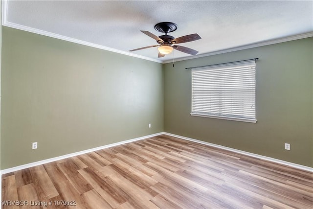 empty room with crown molding, ceiling fan, and light wood-type flooring