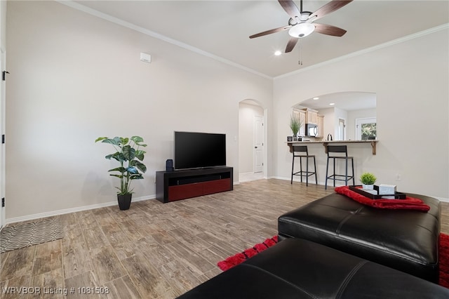 106 Stone Dr, Roland, OK 74954 - living area with arched walkways, ceiling fan, wood finished floors, ornamental molding, and recessed lighting