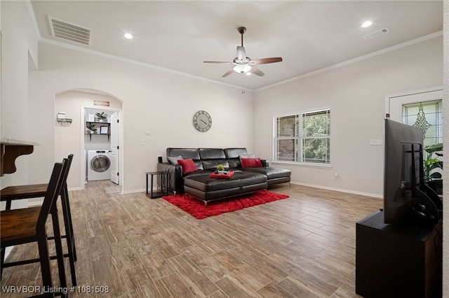106 Stone Dr, Roland, OK 74954 - living area featuring washer / dryer, ceiling fan, arched walkways, plenty of natural light, and ornamental molding