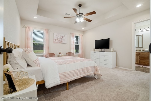 106 Stone Dr, Roland, OK 74954 - carpeted bedroom with multiple windows, a tray ceiling, recessed lighting, ensuite bathroom, and a ceiling fan