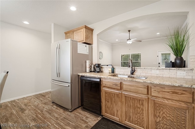 106 Stone Dr, Roland, OK 74954 - kitchen with black dishwasher, freestanding refrigerator, wood finished floors, recessed lighting, and arched walkways
