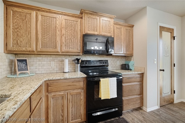 106 Stone Dr, Roland, OK 74954 - kitchen with black appliances, light wood-type flooring, backsplash, and light stone counters