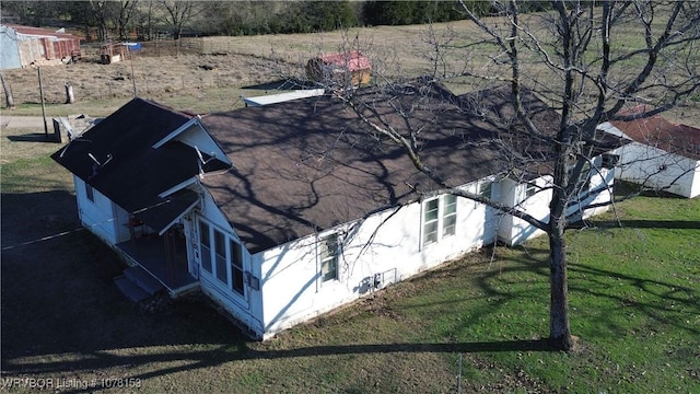 view of property exterior featuring a lawn