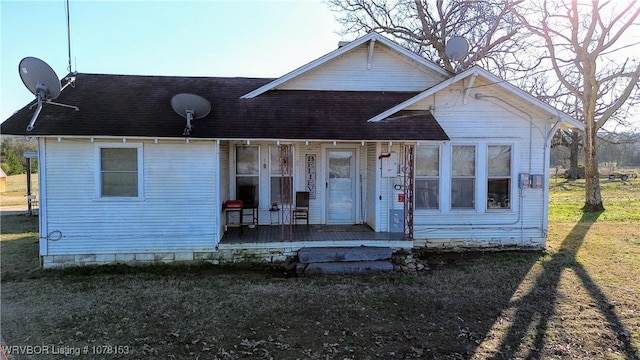 view of front of home featuring covered porch and a front yard