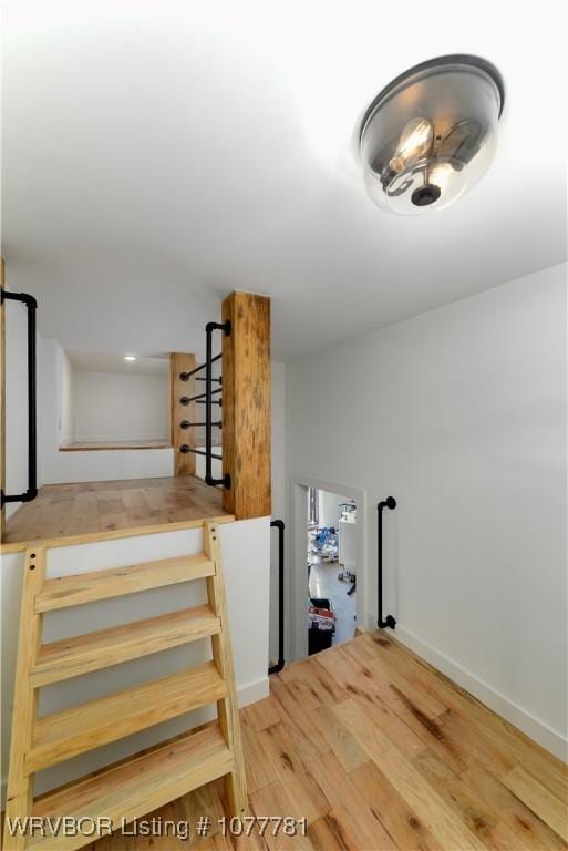 stairway featuring hardwood / wood-style flooring