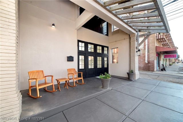 view of exterior entry featuring a pergola