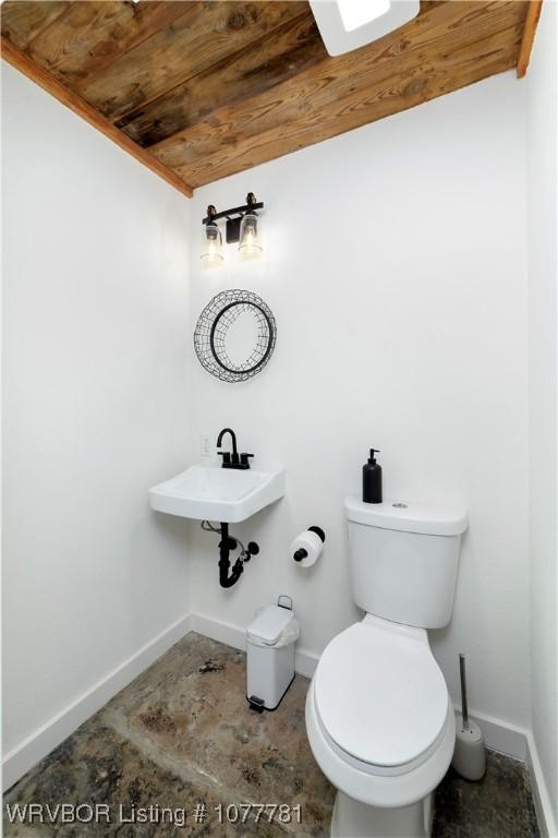 bathroom with sink, toilet, lofted ceiling, and wood ceiling