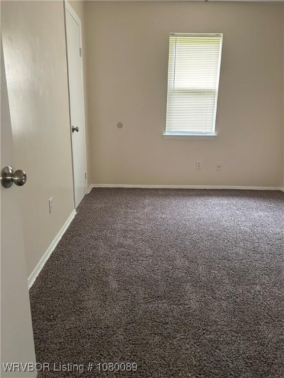102 Gamma Cir, Roland, OK 74954 - carpeted spare room featuring baseboards