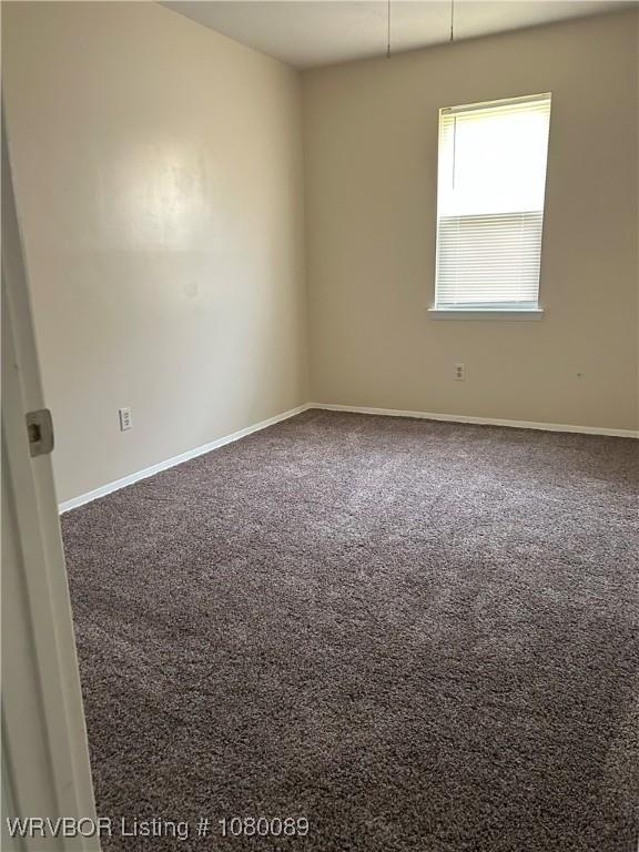 102 Gamma Cir, Roland, OK 74954 - spare room featuring baseboards and carpet flooring