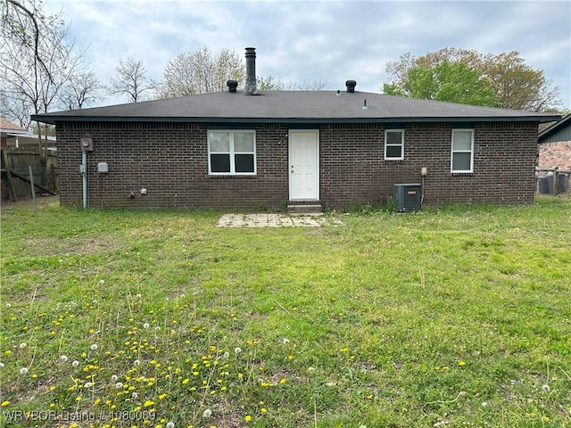 102 Gamma Cir, Roland, OK 74954 - rear view of property with a yard, brick siding, cooling unit, and fence