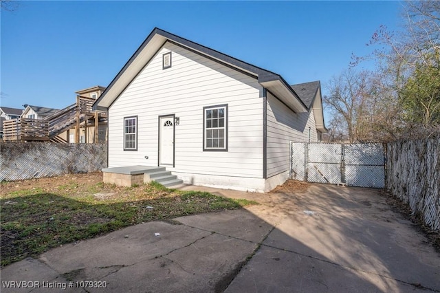 rear view of house with a gate and fence