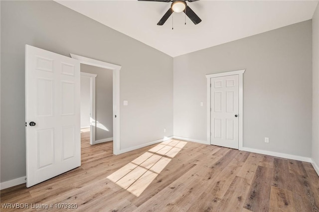 unfurnished bedroom featuring a ceiling fan, baseboards, and light wood finished floors