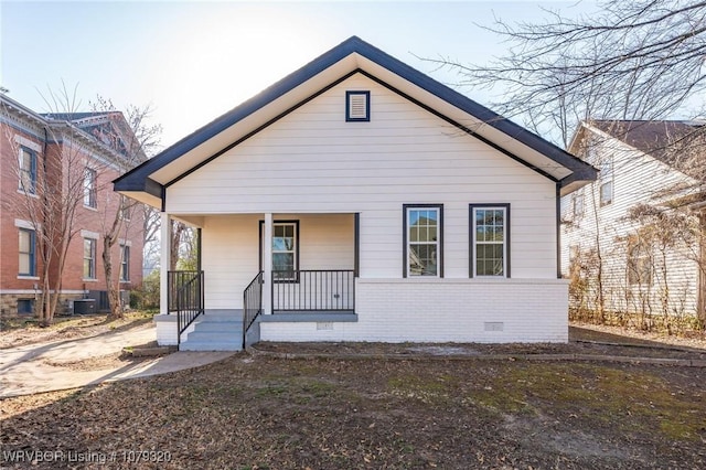 bungalow-style house featuring crawl space, central AC unit, and covered porch