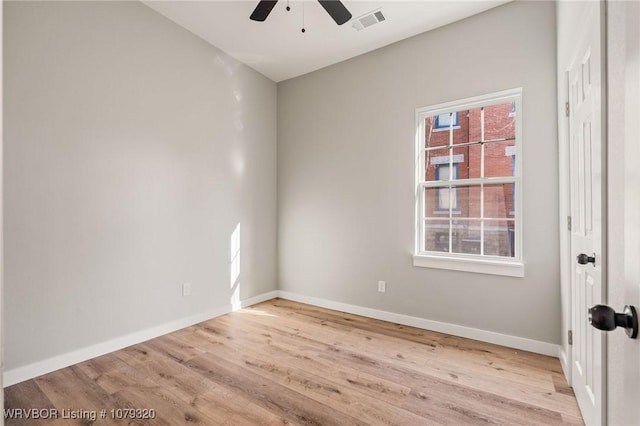 empty room featuring visible vents, baseboards, light wood-type flooring, and a ceiling fan