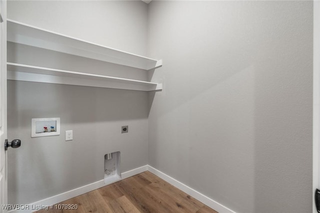 laundry area with wood finished floors, baseboards, hookup for an electric dryer, laundry area, and washer hookup