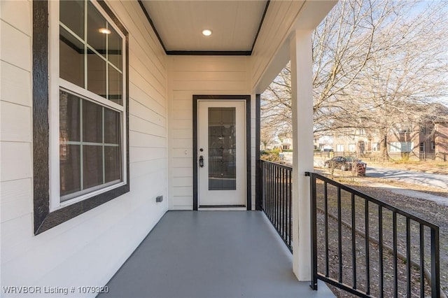 view of exterior entry featuring a balcony