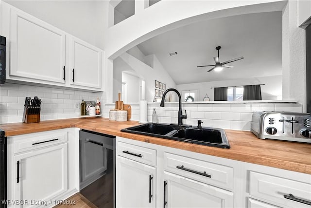 kitchen with wooden counters, ceiling fan, decorative backsplash, arched walkways, and a sink