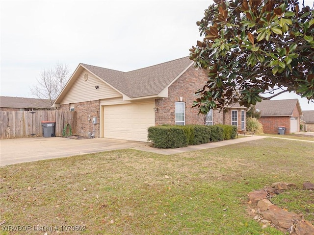 view of front of home featuring brick siding, a front lawn, fence, driveway, and an attached garage