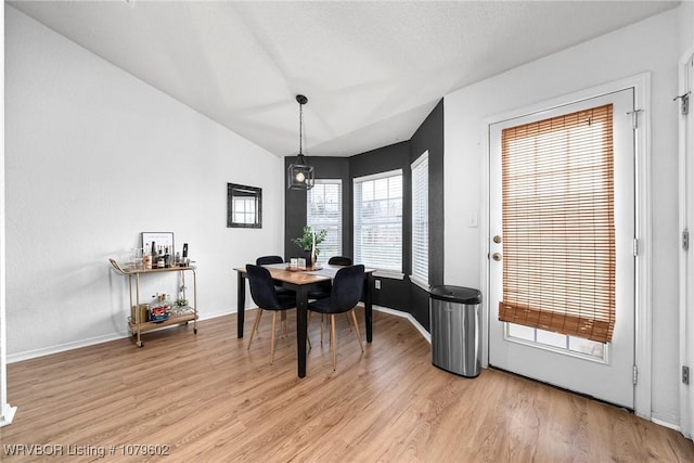 dining room featuring light wood-style flooring and baseboards