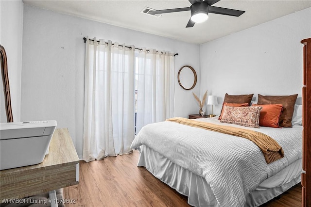 bedroom with a ceiling fan and wood finished floors