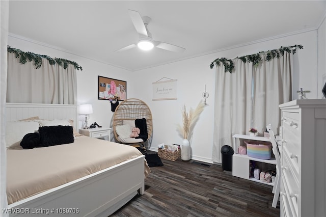 bedroom featuring crown molding, ceiling fan, visible vents, and dark wood-style floors