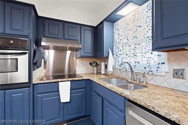 kitchen featuring under cabinet range hood, stainless steel appliances, blue cabinetry, and a sink