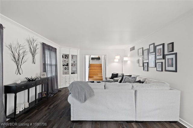 living area featuring dark wood-type flooring, crown molding, visible vents, and stairway